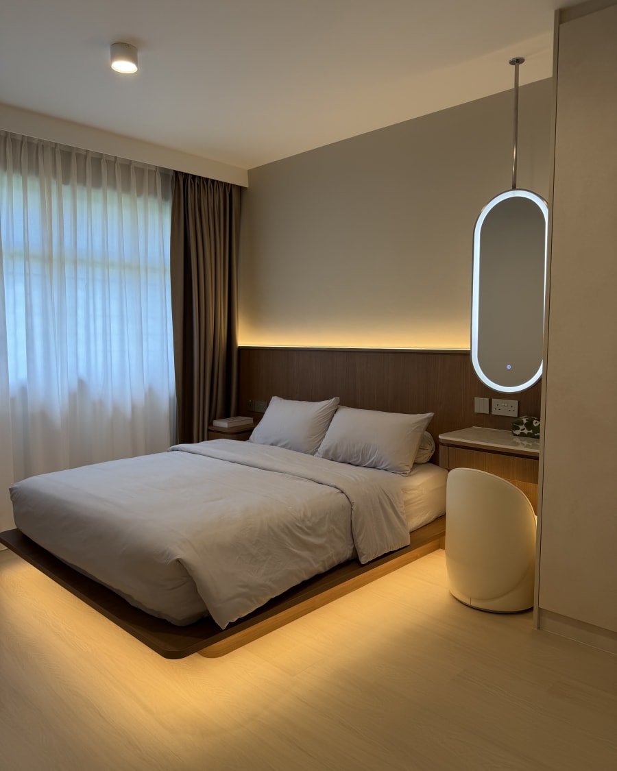 Completed master bedroom at 470C Fernvale — platform bed with cove lighting, backlit mirror and vinyl flooring by Heng Fa Construction