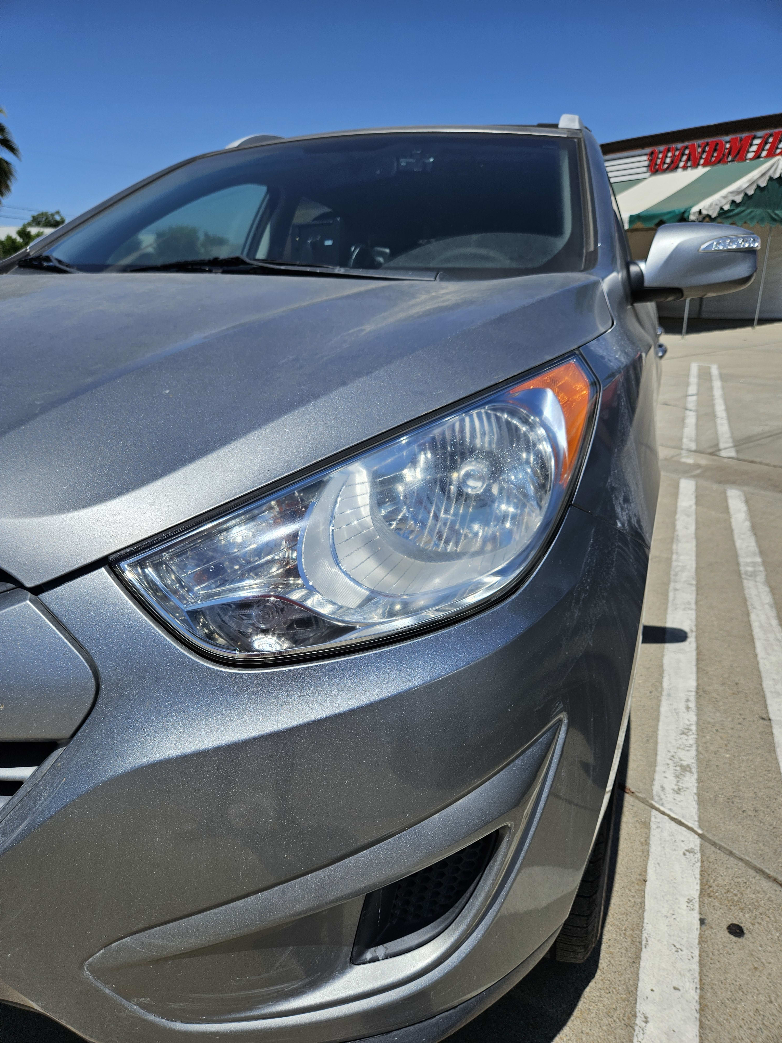 Headlight restoration on a blue car, after repair
