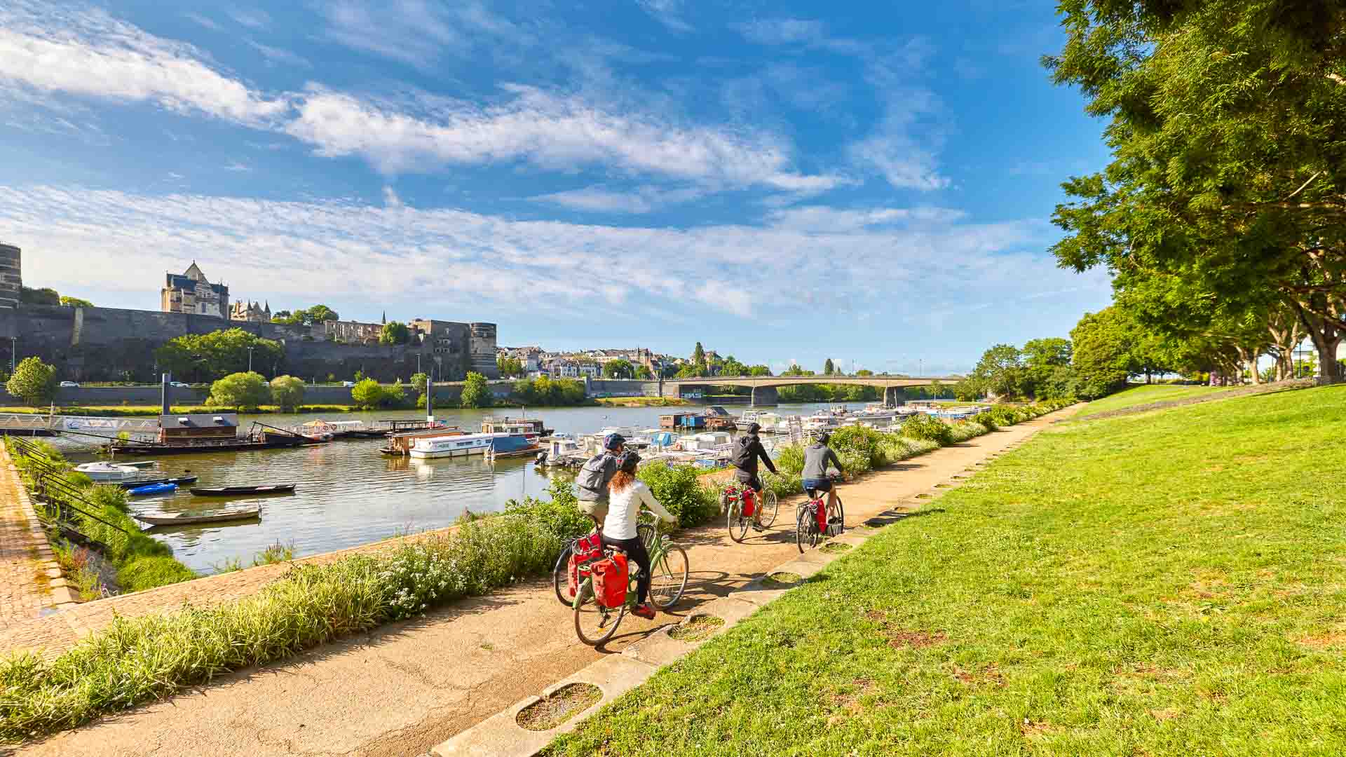A family cycling on a path through the French countryside