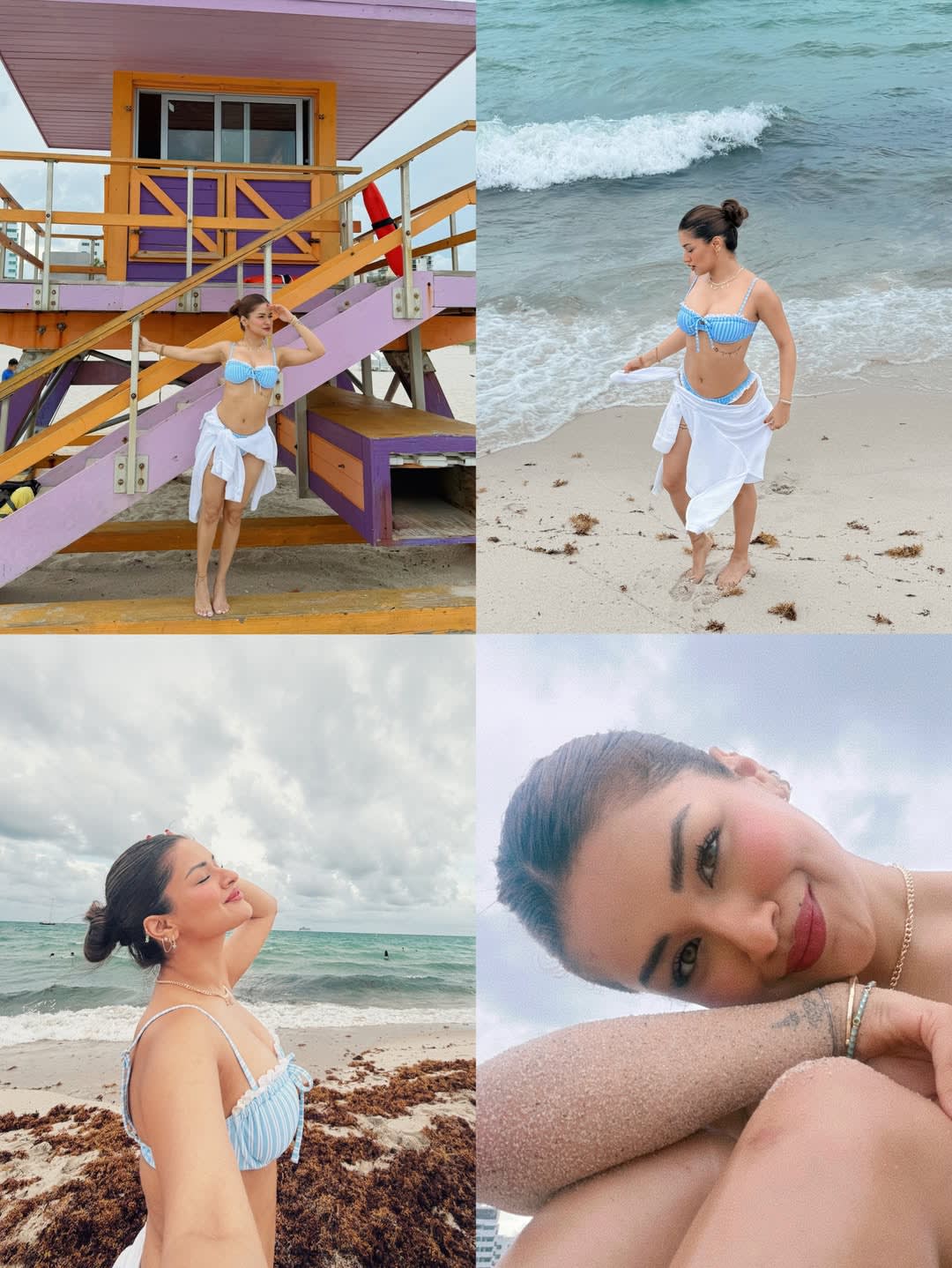 Avneet Kaur posing on a Miami beach in a blue striped bikini and white sarong, with a colorful lifeguard stand and ocean waves in the background.