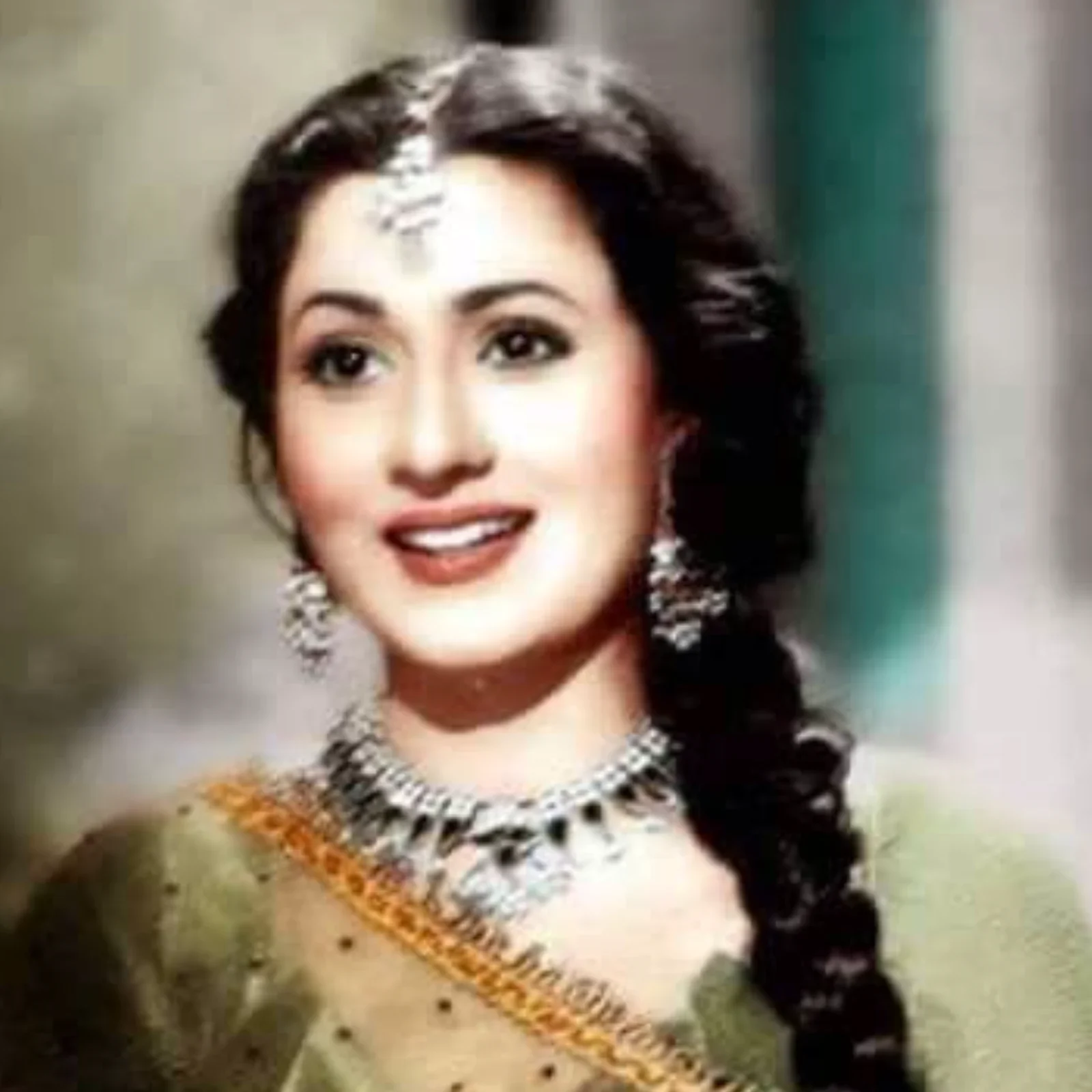 Madhubala smiling in traditional attire with jewelry.