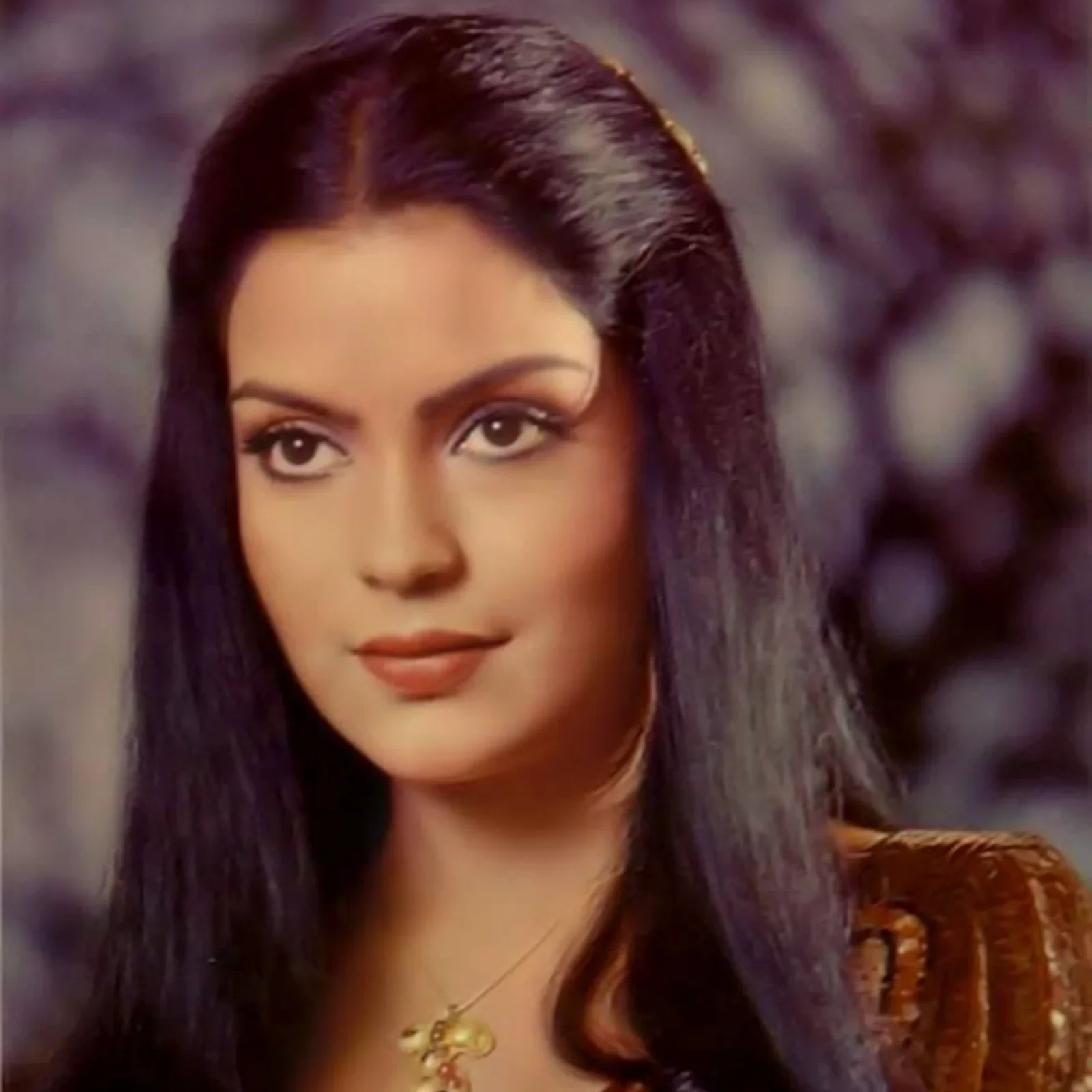 Zeenat Aman with long dark hair and a delicate necklace, exuding classic glamour.