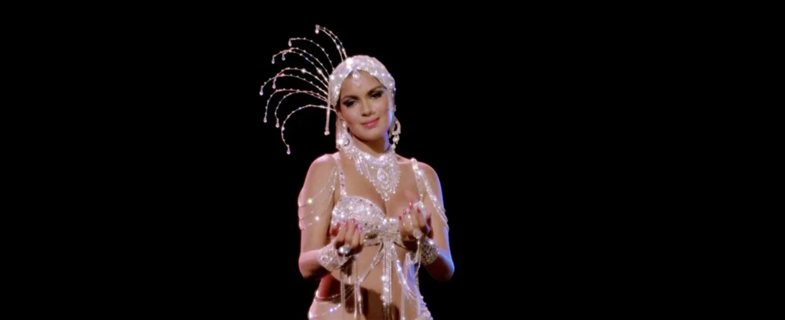 Zeenat Aman in a sparkling performance outfit with a dramatic headpiece.
