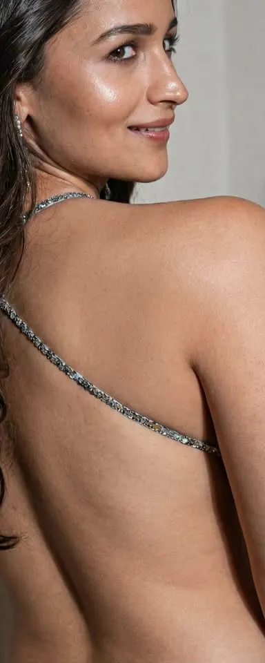 Alia Bhatt looking over her shoulder showing off her backless embellished outfit
