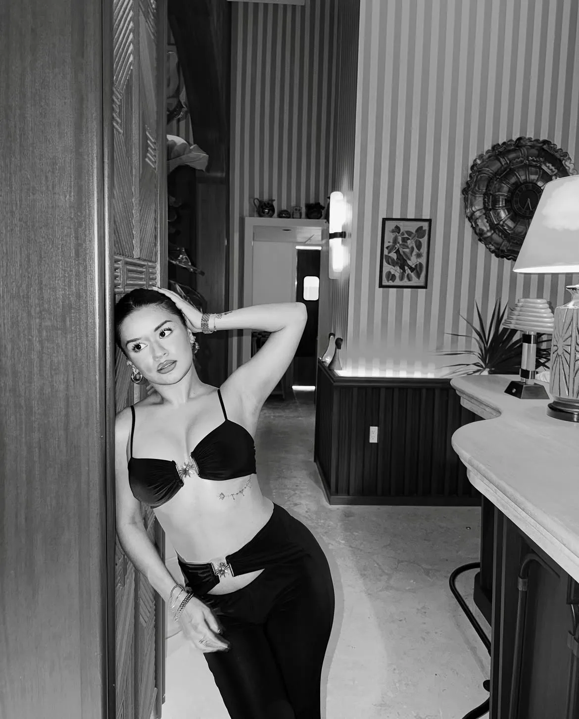 Avneet Kaur wearing a black bralette and low-rise pants in a monochrome photo