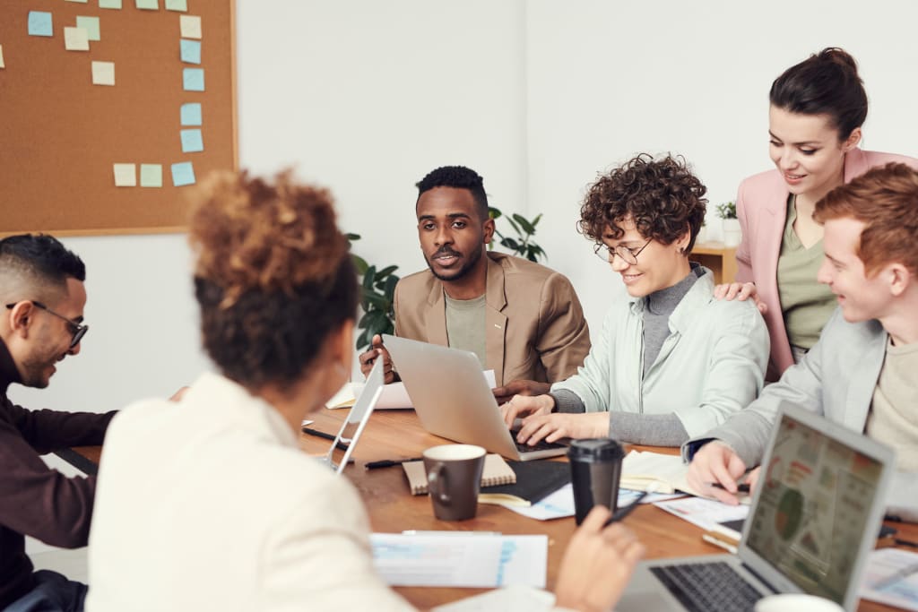 people sitting around table collaborating
