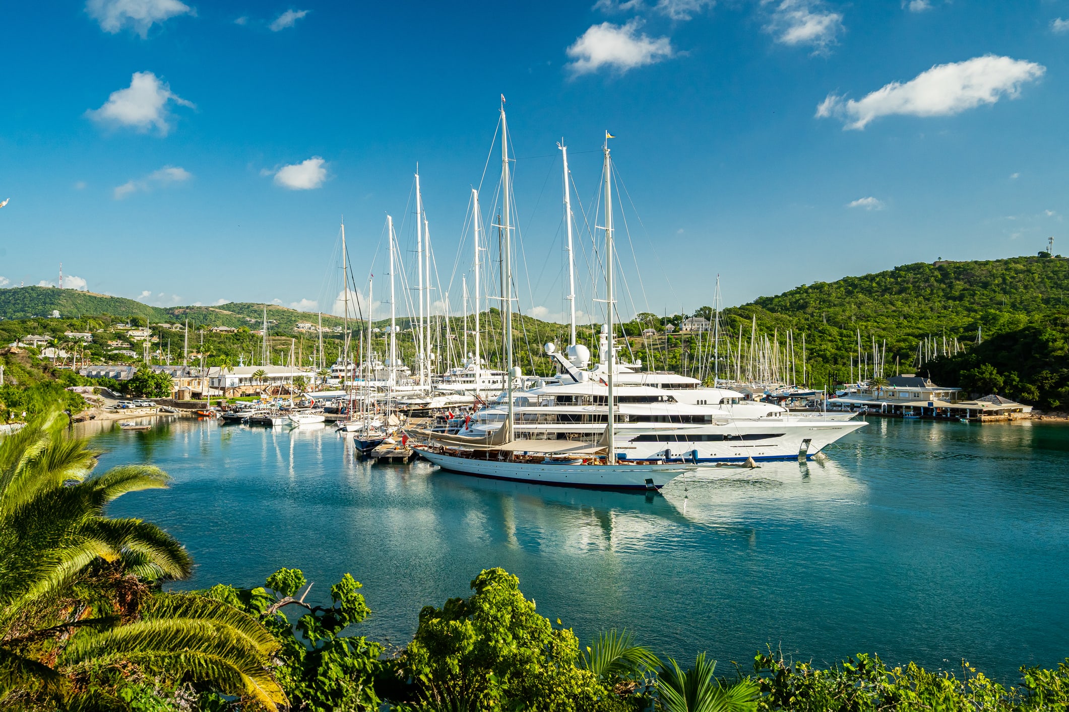 Wide angle shots of famous English Harbour in Antigua taken from a viewpoint, overlooking the port and marina with super yachts moored at the dock