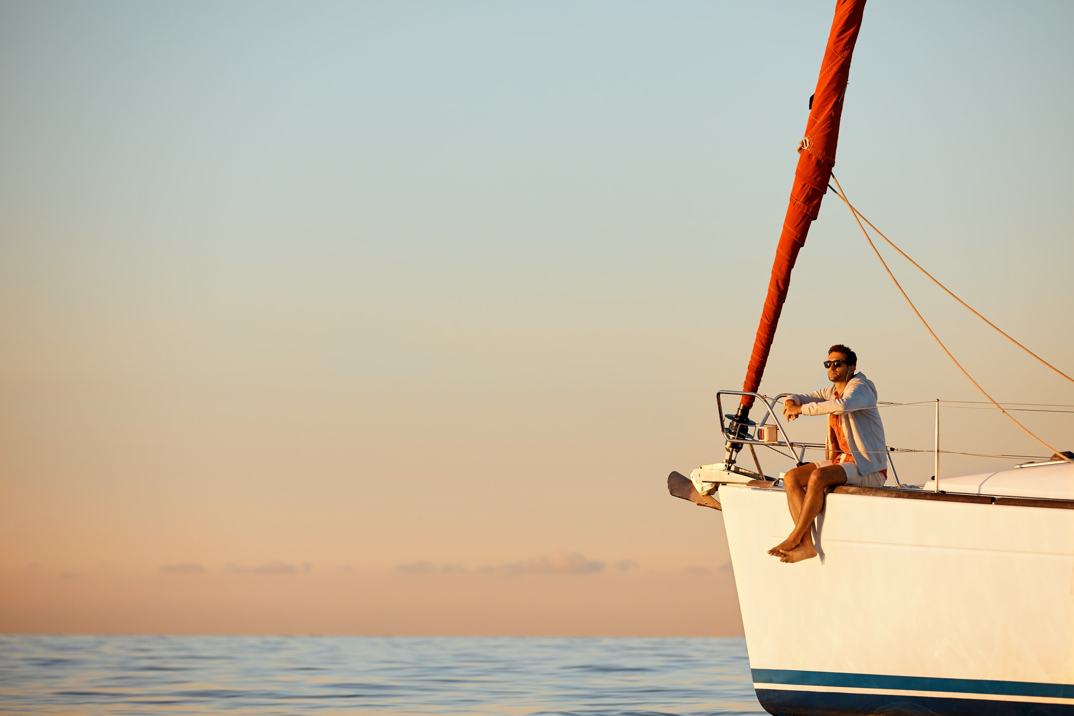 Shot of a handsome young man going for an ocean cruise on a boat