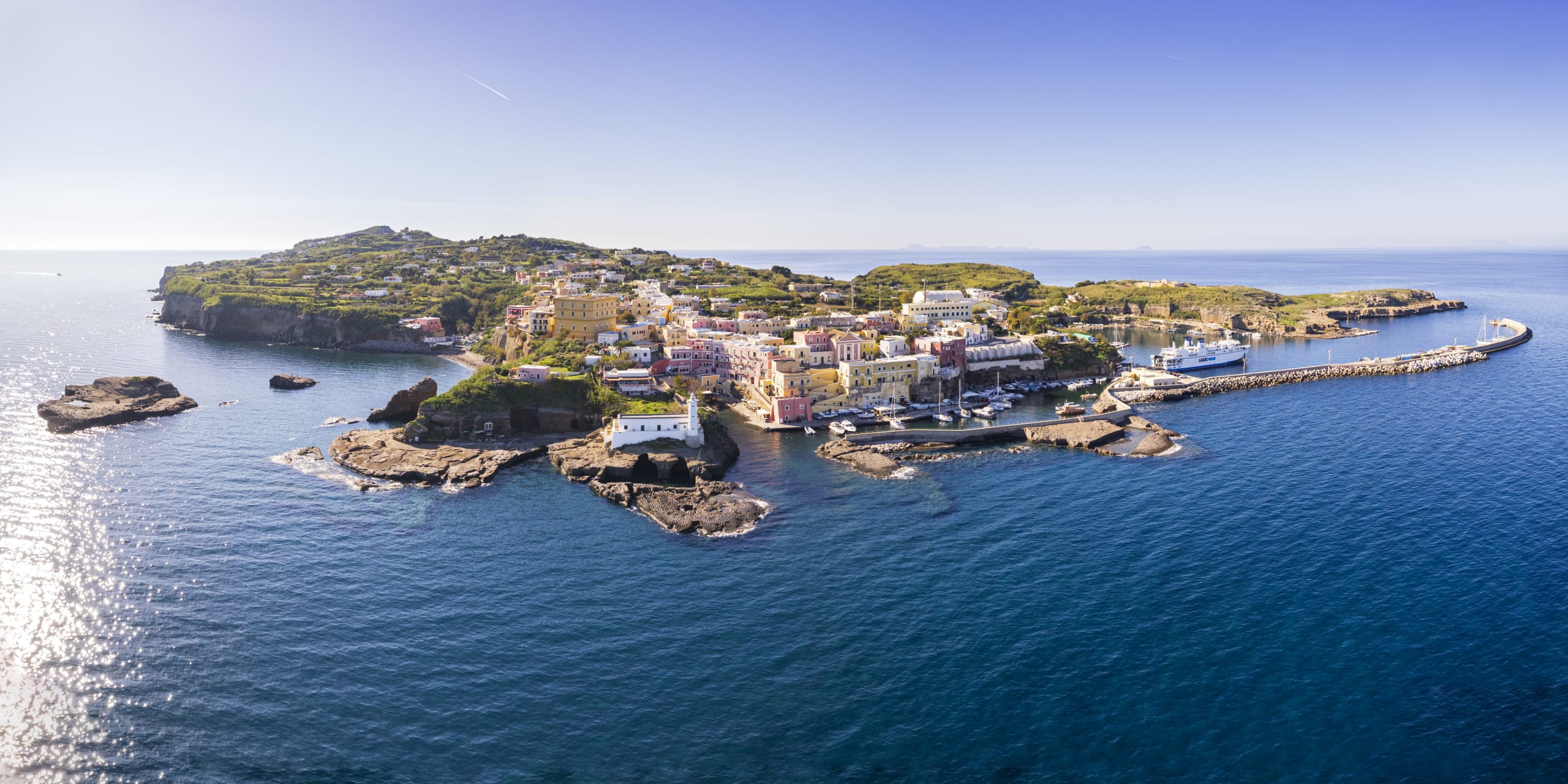 Aerial panoramic shot of the italian island of Ventotene with colorful buildings and the roman harbour, day time, Ventotene, Pontine archipelago, Latina province, Latium, Italy, Mediterranean sea, Europe