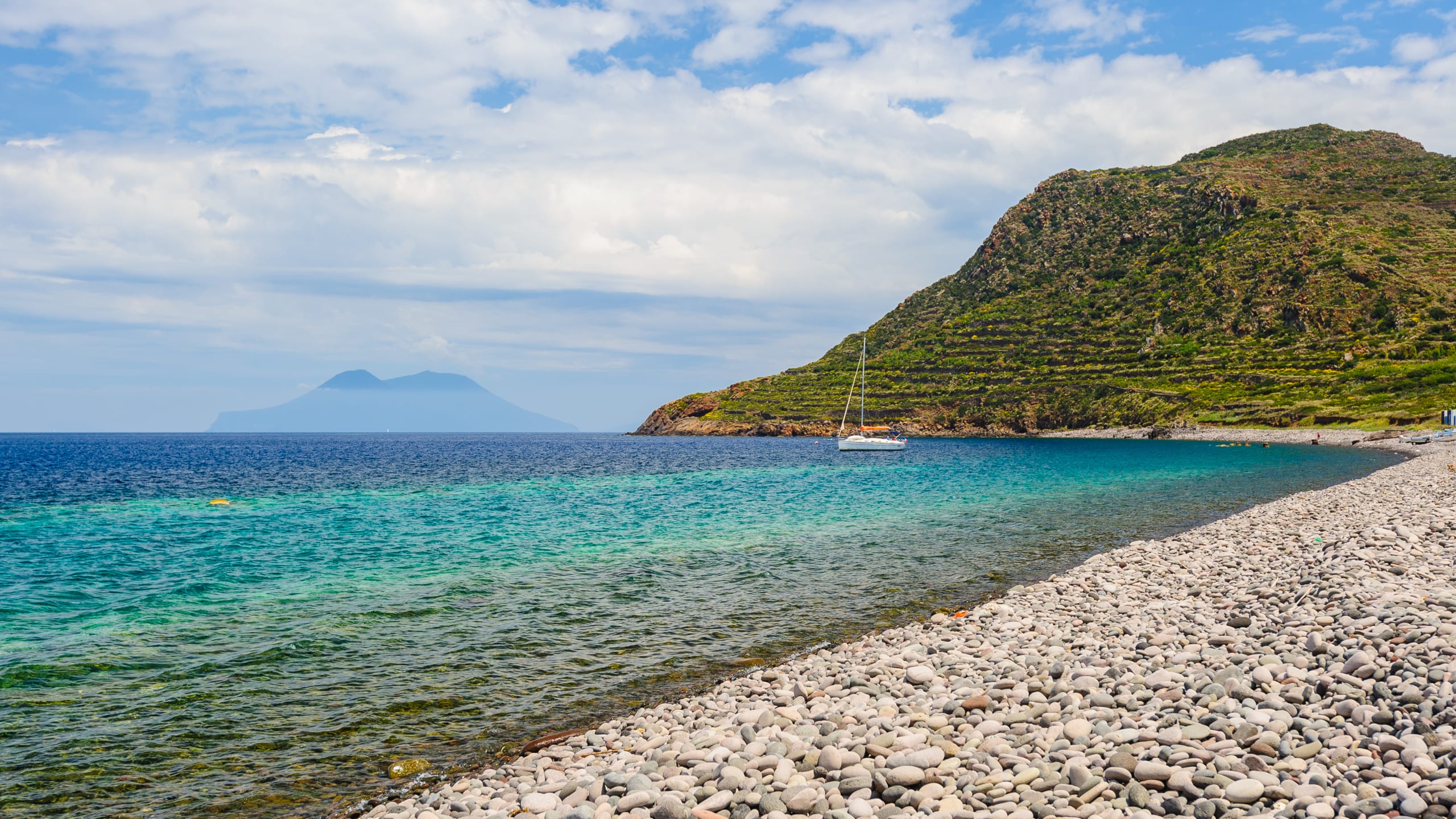 Filicudi island pebble beach on a hot summer day, Italy.
