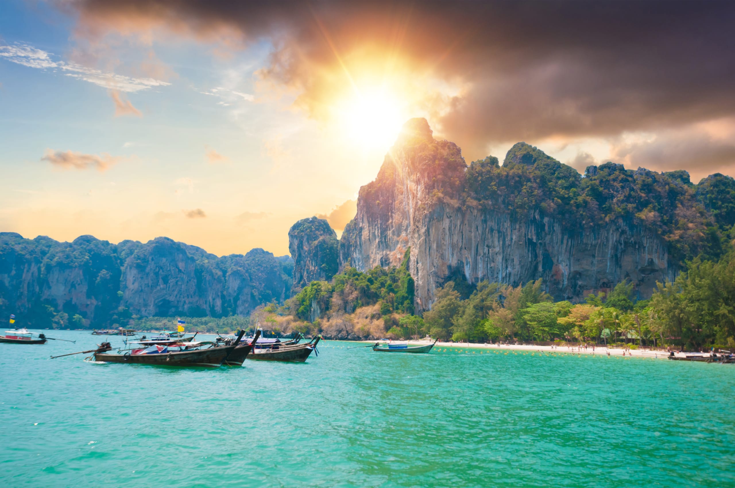 Beautiful sunset at tropical sea with long tail boat in south thailand