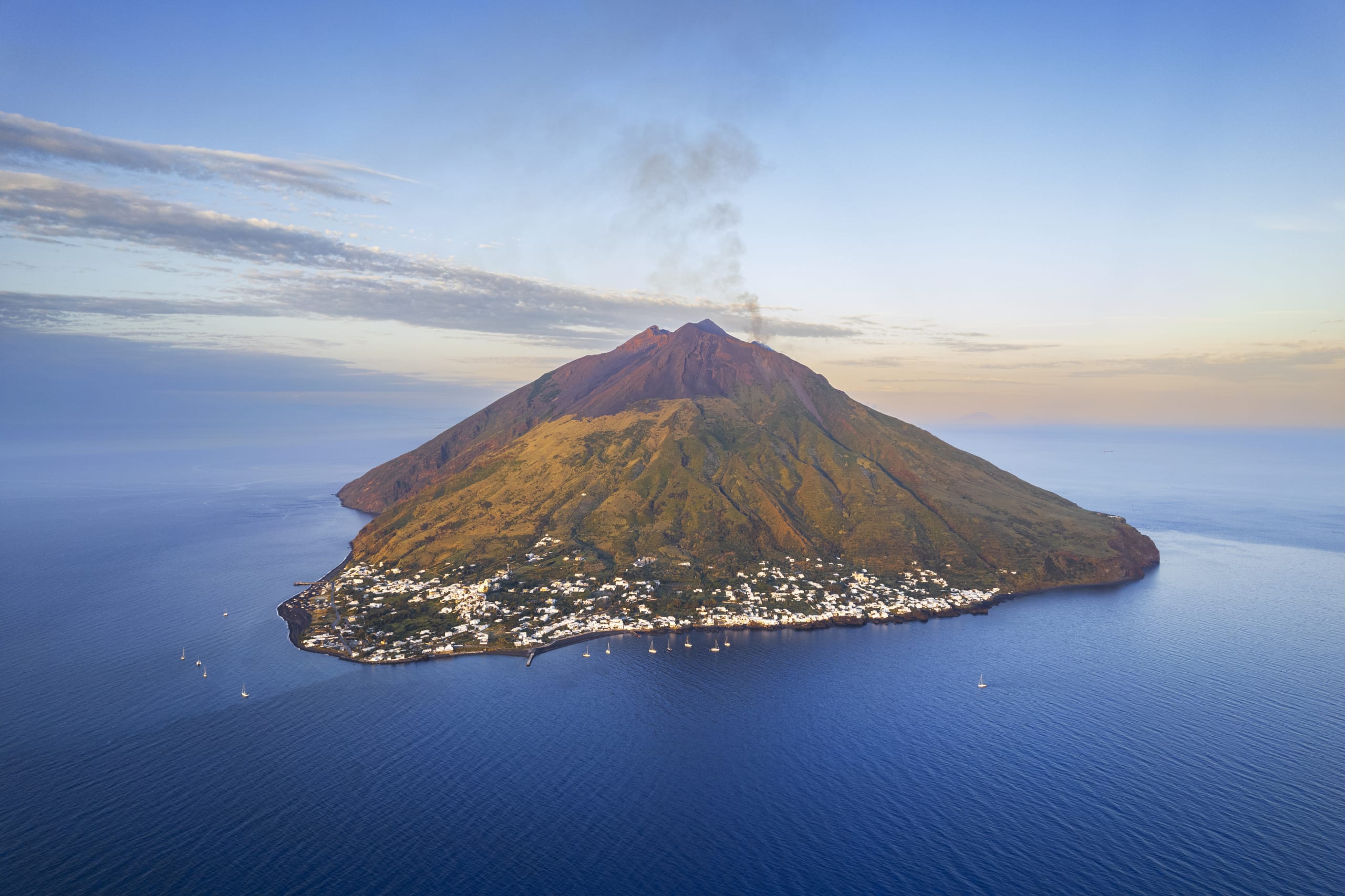 Aerial view of Stromboli volcano with smoke seen from the drone, Stromboli island, Aeolian archipelago, Messina, Tyrrhenian Sea, Mediterranean Sea, Sicily, Italy