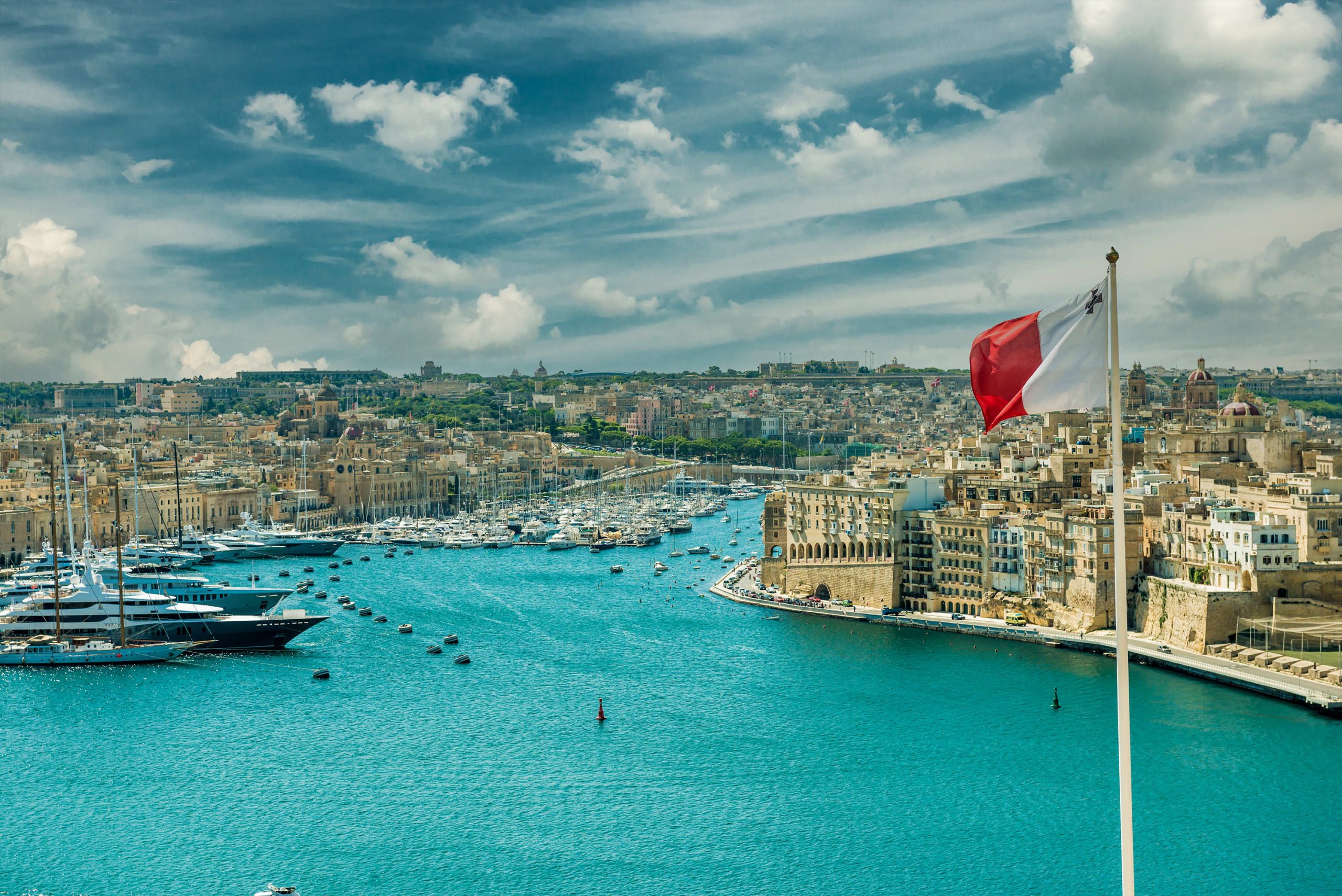 panoramic view on Valletta with the flag of Malta in the foreground