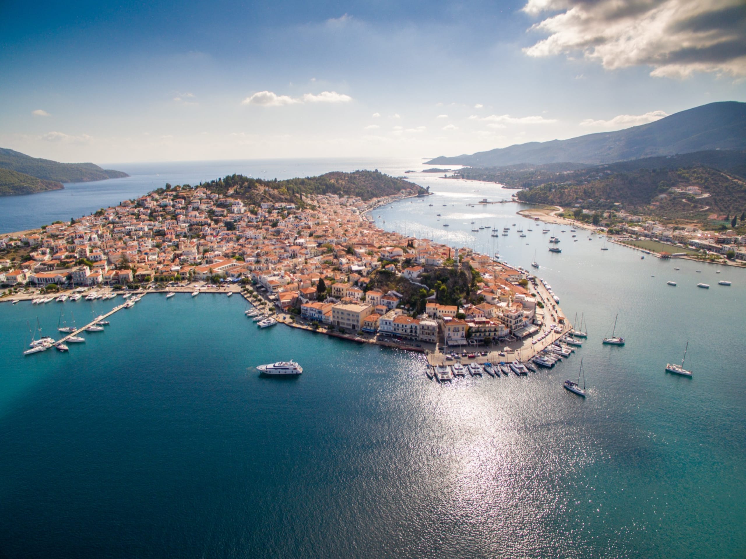 Yachts, sailboats and catamarans moored in port Piraeus in Athens at early morning. Aerial view from drone perspective