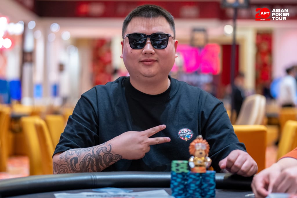 Poker player with chips and teddy bear.