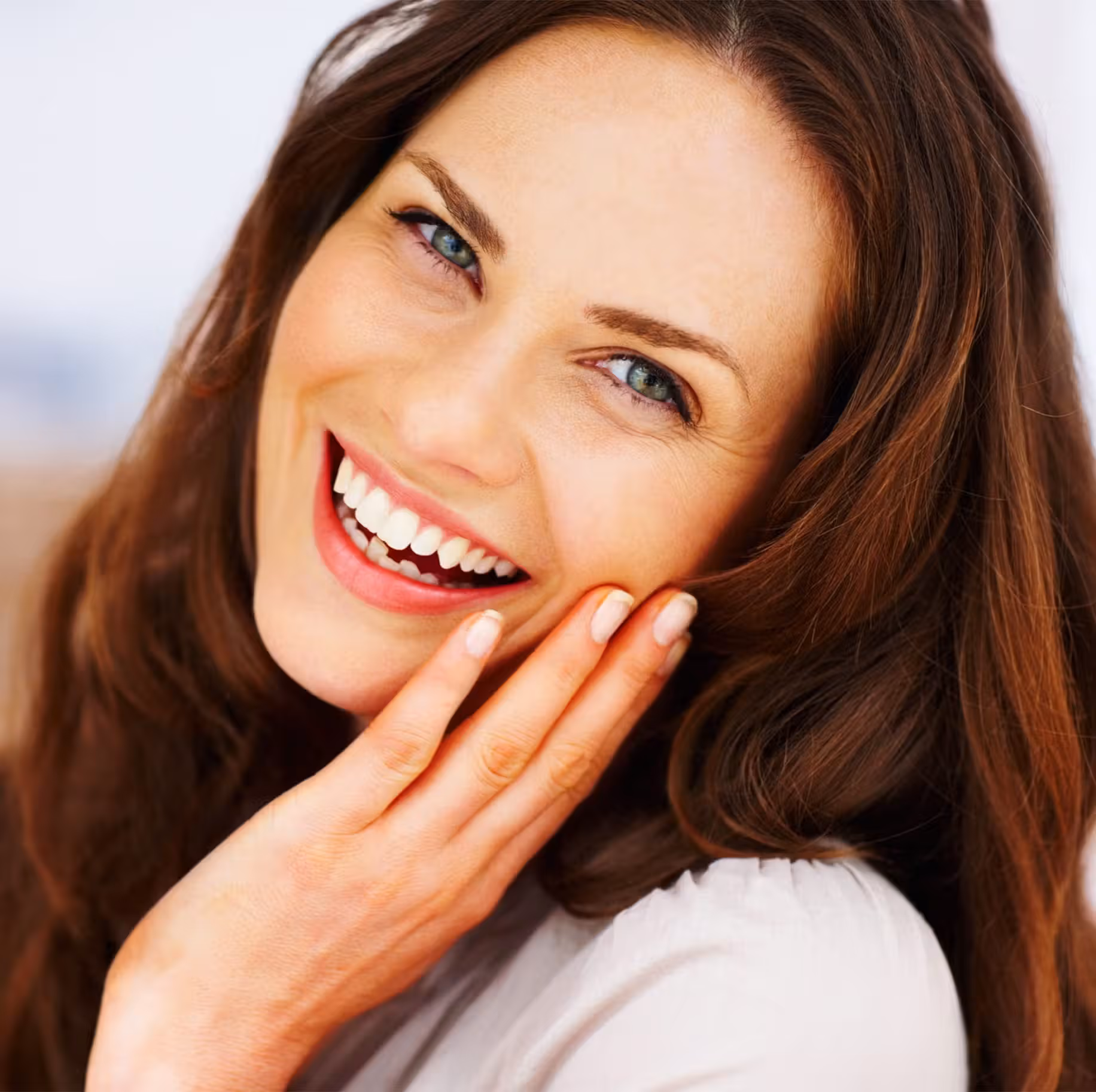 Brunette woman touching face