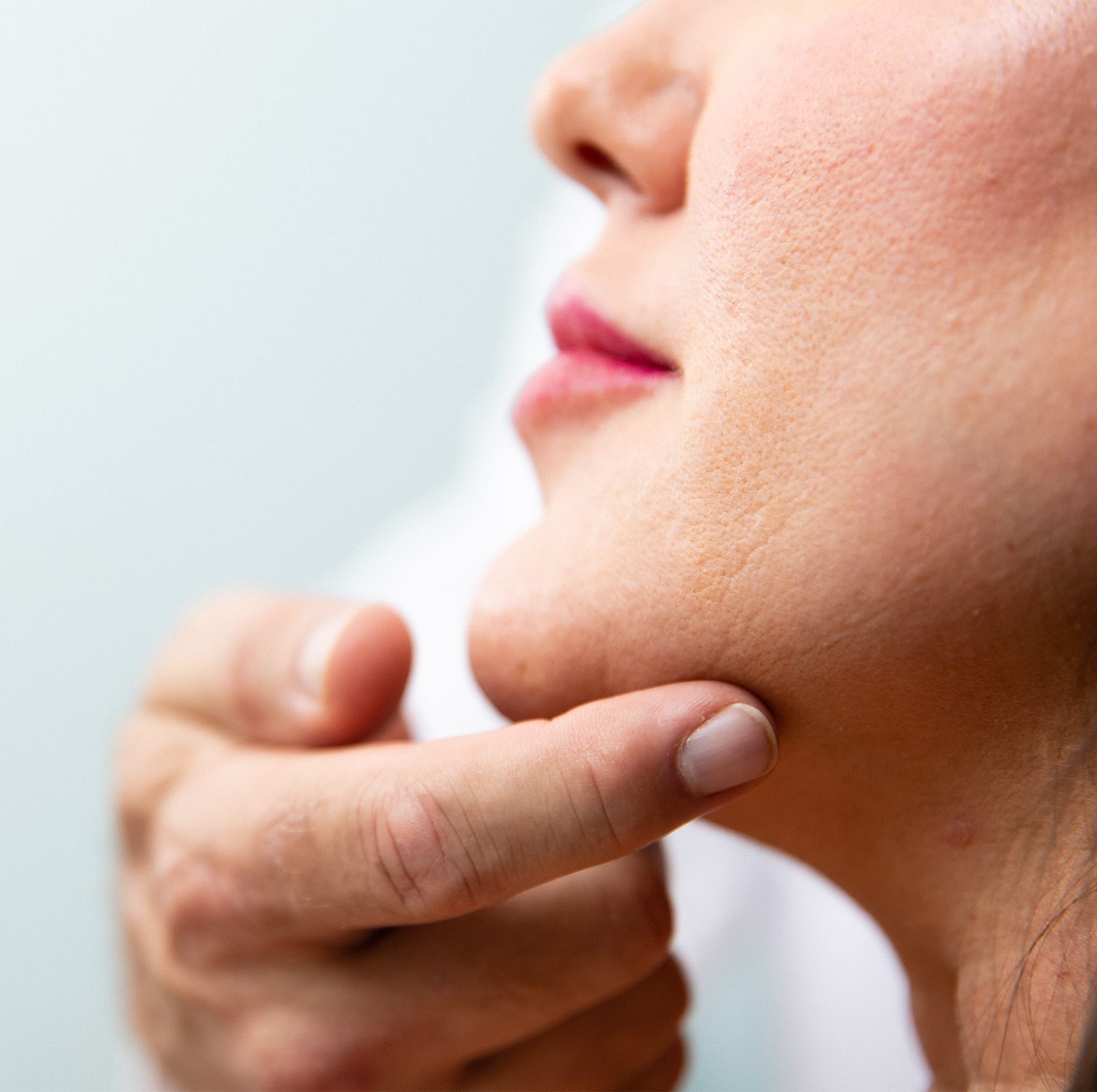 Woman touching her neck