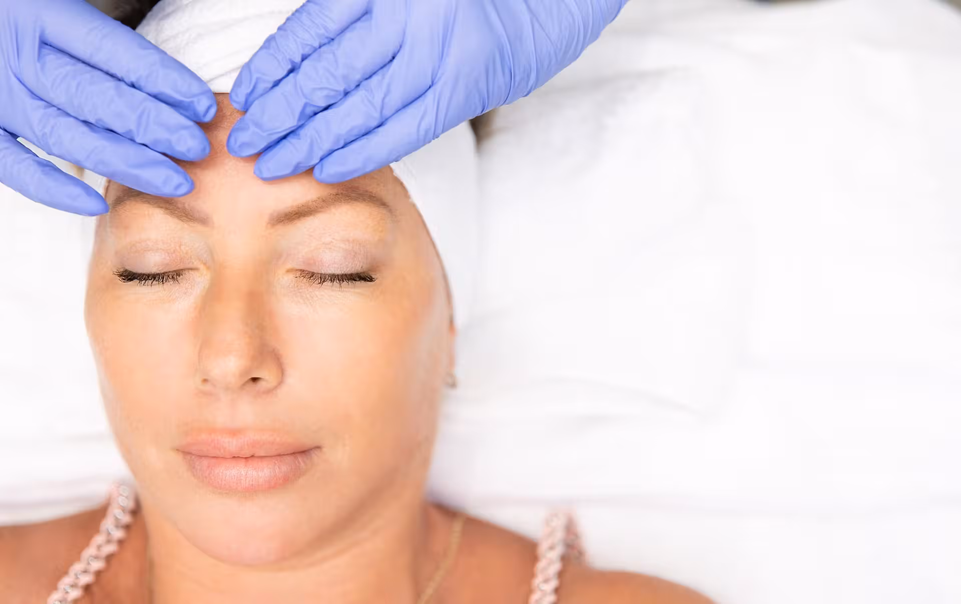 Woman receiving facial treatment