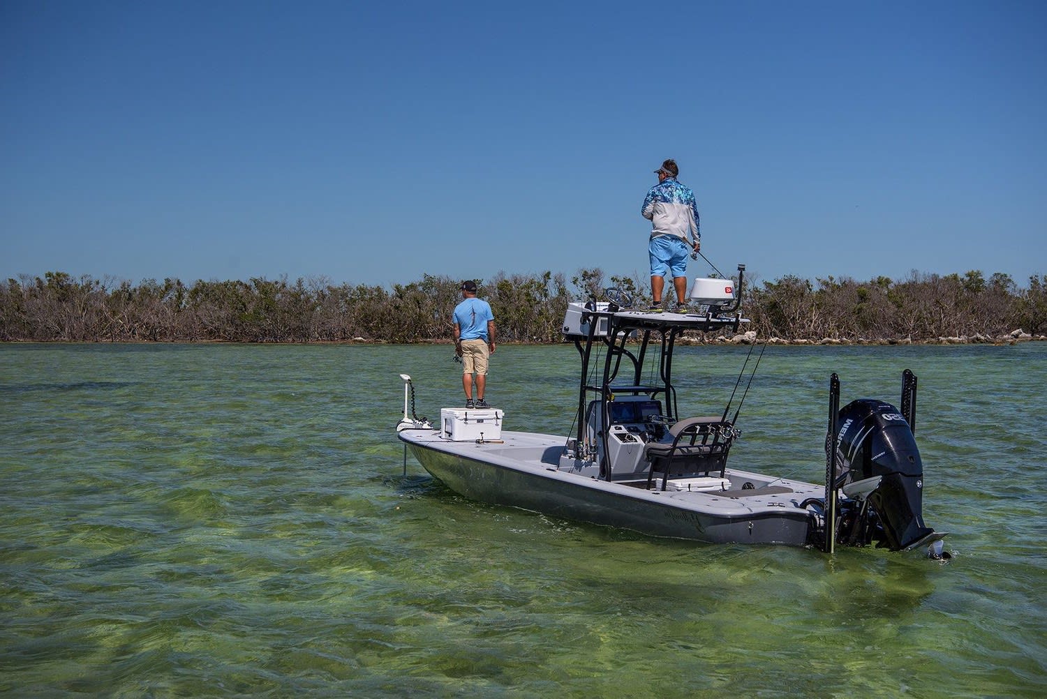 A man and a guide fly fishing saltwater flats