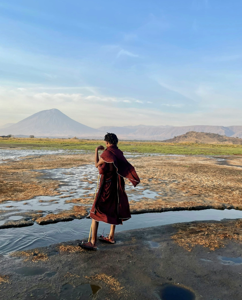 Harsh volcanic desert wrapped around a blood-tinged, flamingo-crowded alkaline lake.