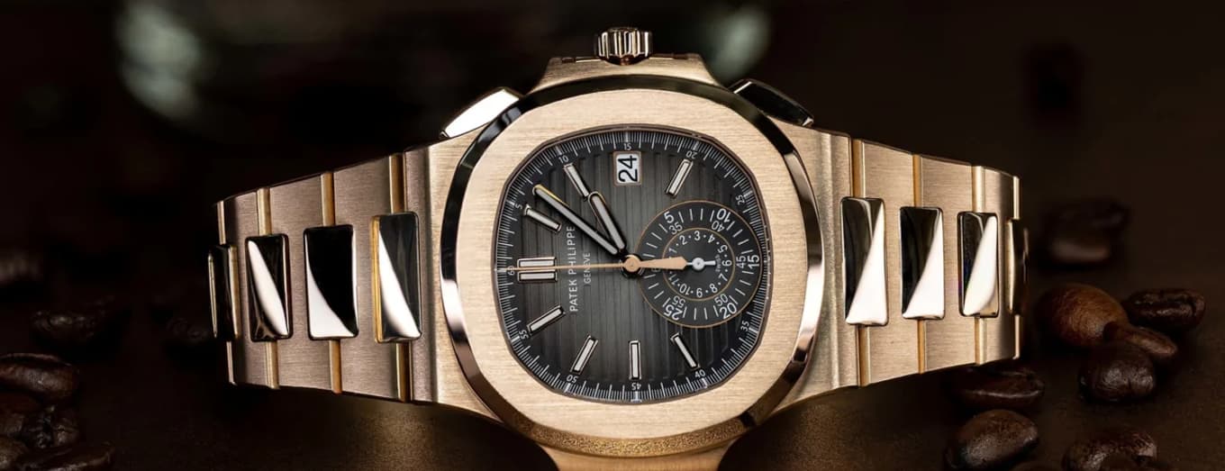 Patek Philippe Nautilus rose gold on textured wood at golden hour