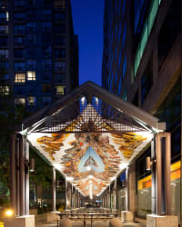 Image of large banner installed in outdoor architectural pavilion.