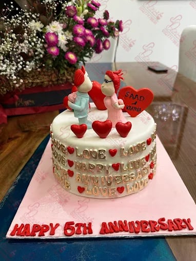 White Anniversary Cake with Figurines Faisalabad