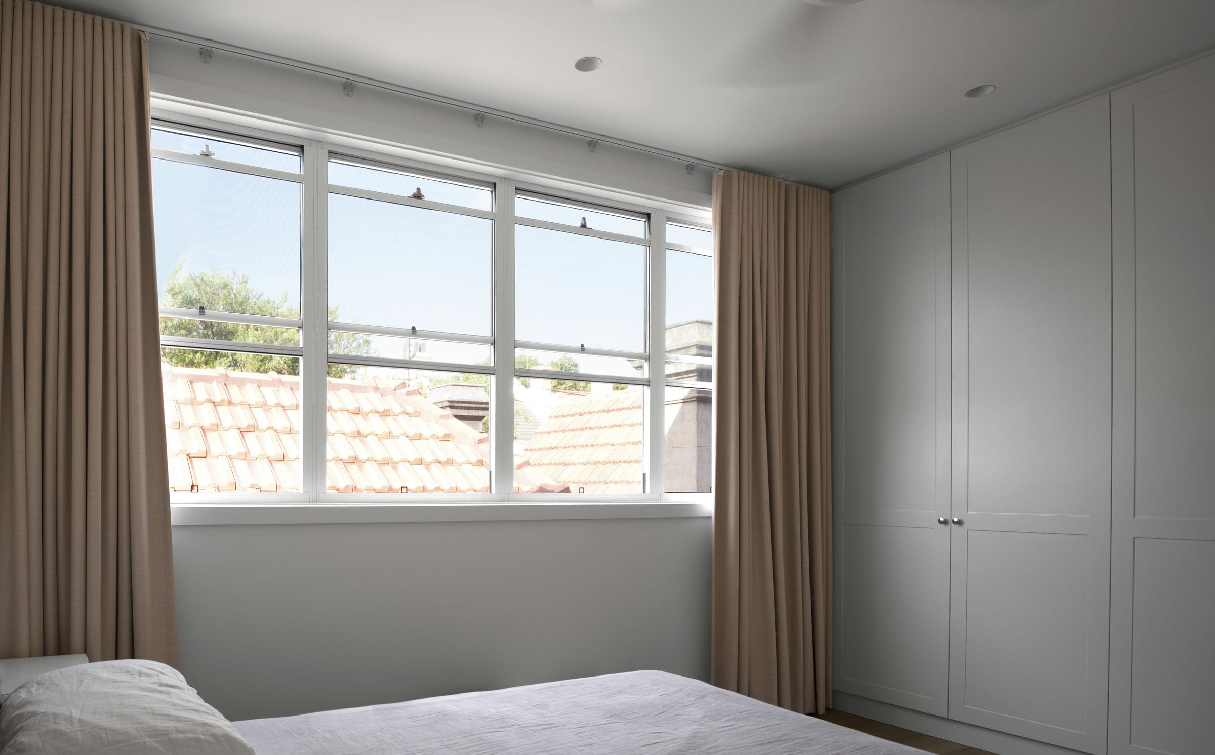 Master bedroom in the contemporary extension overlooking rooftops