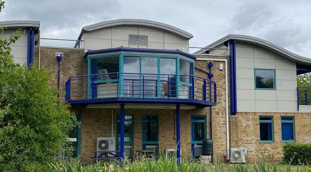 Completed office block in its new bright blue scheme.