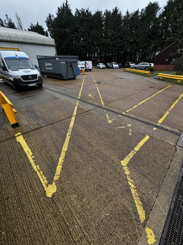 Weathered, worn walkway coating before the works.
