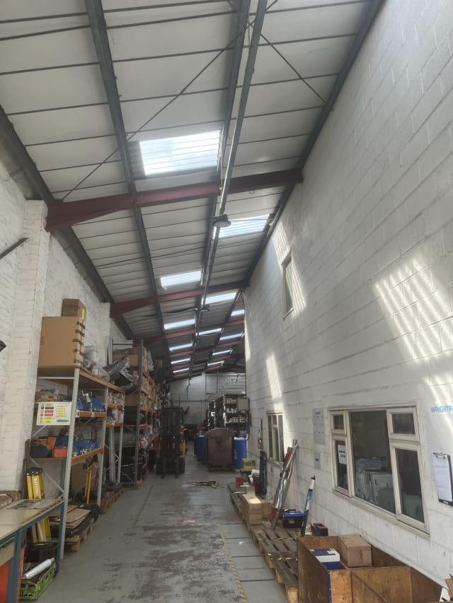 New translucent rooflight sheets fitted to the asbestos roof.
