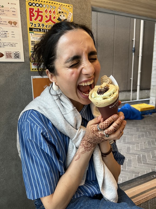 Deeva eating a crepe from NagiCrepe on Togoshi Ginza Shopping Street