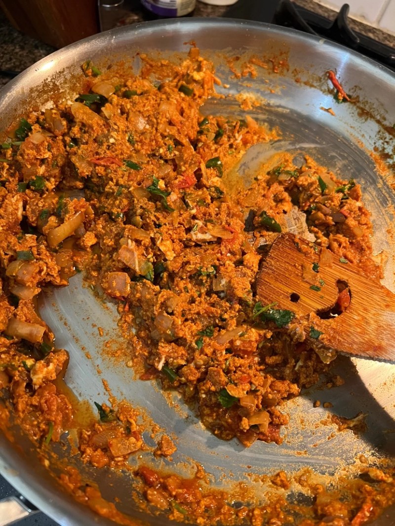 eggs and vegetbales cooking in a pan for desi eggs