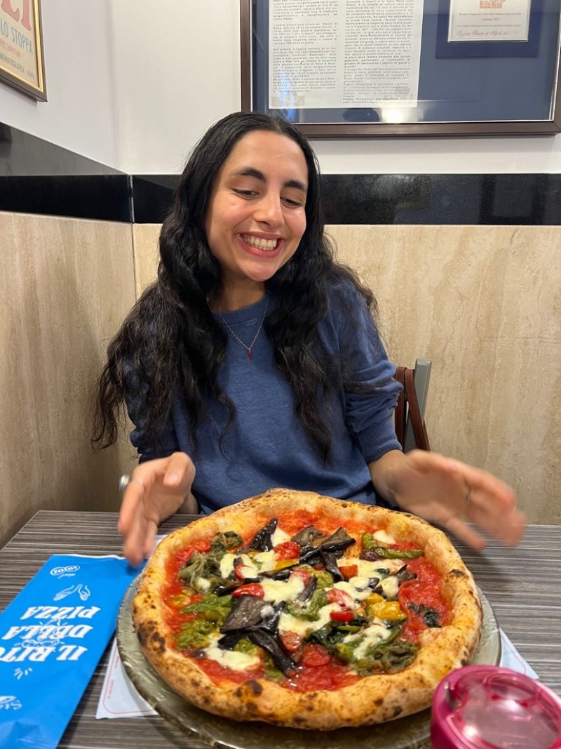 Deeva eating pizza in Naples