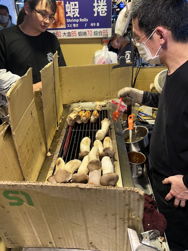 Mushrooms being grilled at a night market