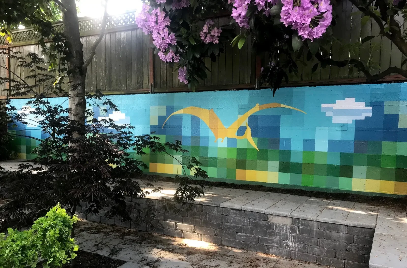 Golden Bird in Pixelated Landscape Mural in Portland, OR