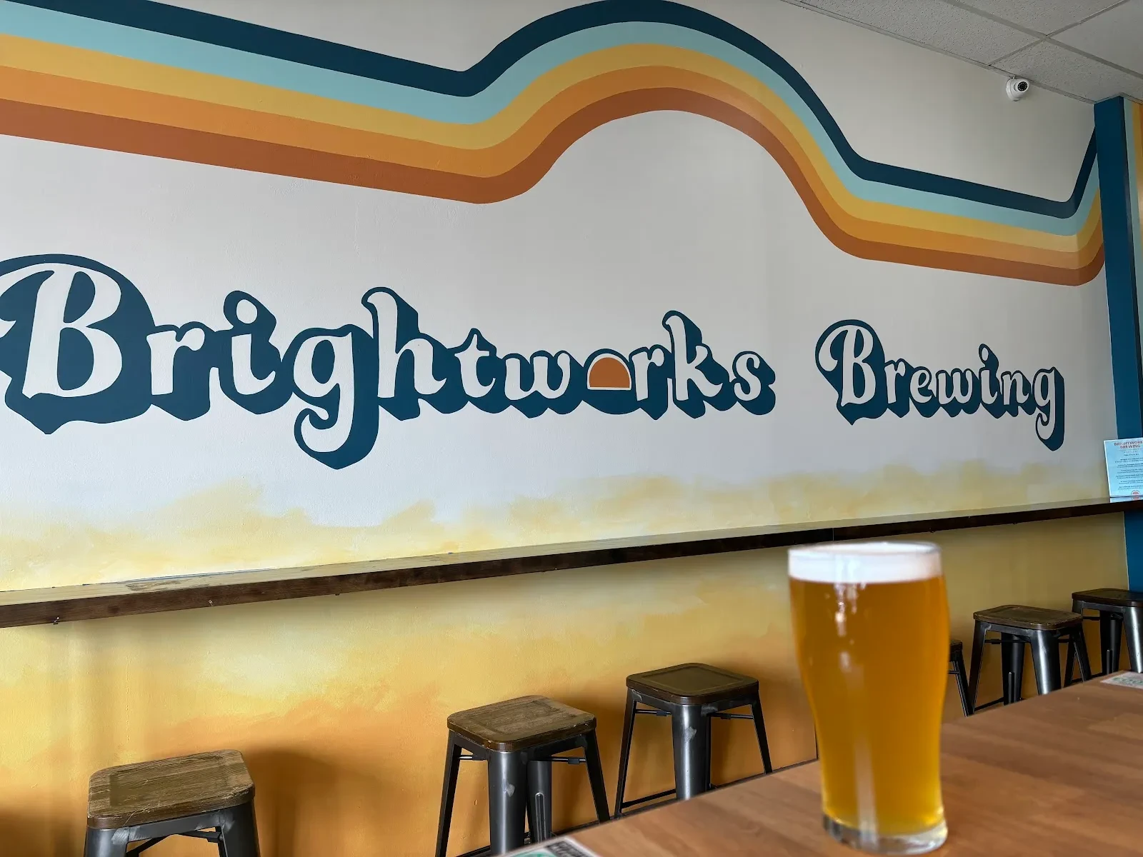 Layered Waves in Golden and Teal Mural in Alexandria, VA