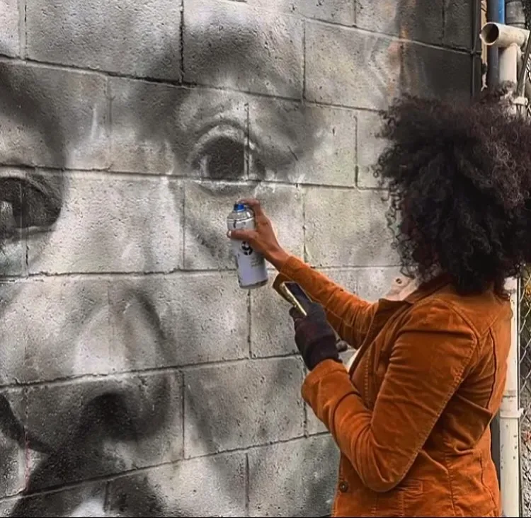 Artist Painting Portrait on Stone Wall Mural in Richardson, TX
