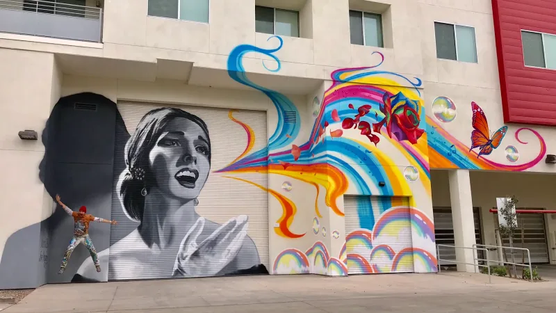 Woman's Profile Merging Into Rainbow Waves Mural in Tucson, AZ in Tucson