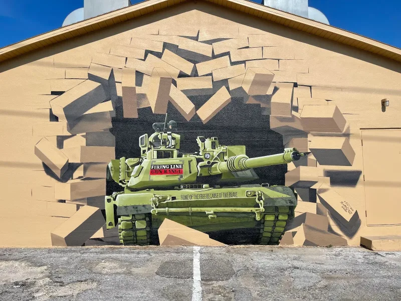 Green Tank Bursting Through Brick Wall Mural in Lakeland, FL in Lakeland