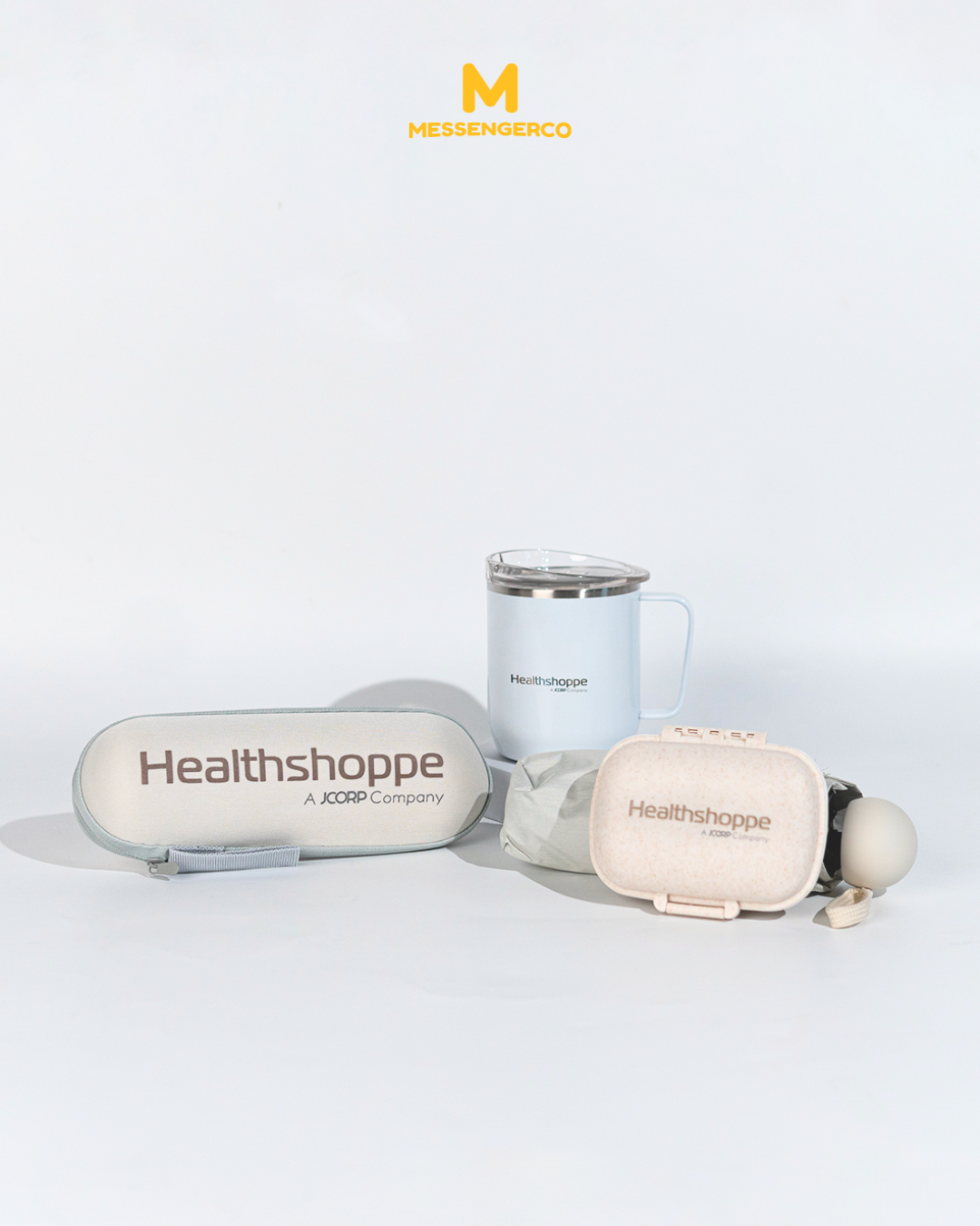 Advertisement for KPJ Health Shoppe featuring a custom branded mug and umbrella side-by-side, with the shop's name and logo prominently displayed.