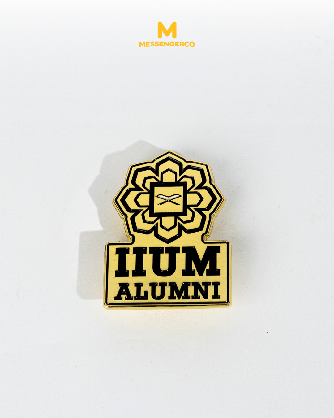 Customised enamel pin for IIUM alumni with space for own design, featuring metallic finish and black backing card.