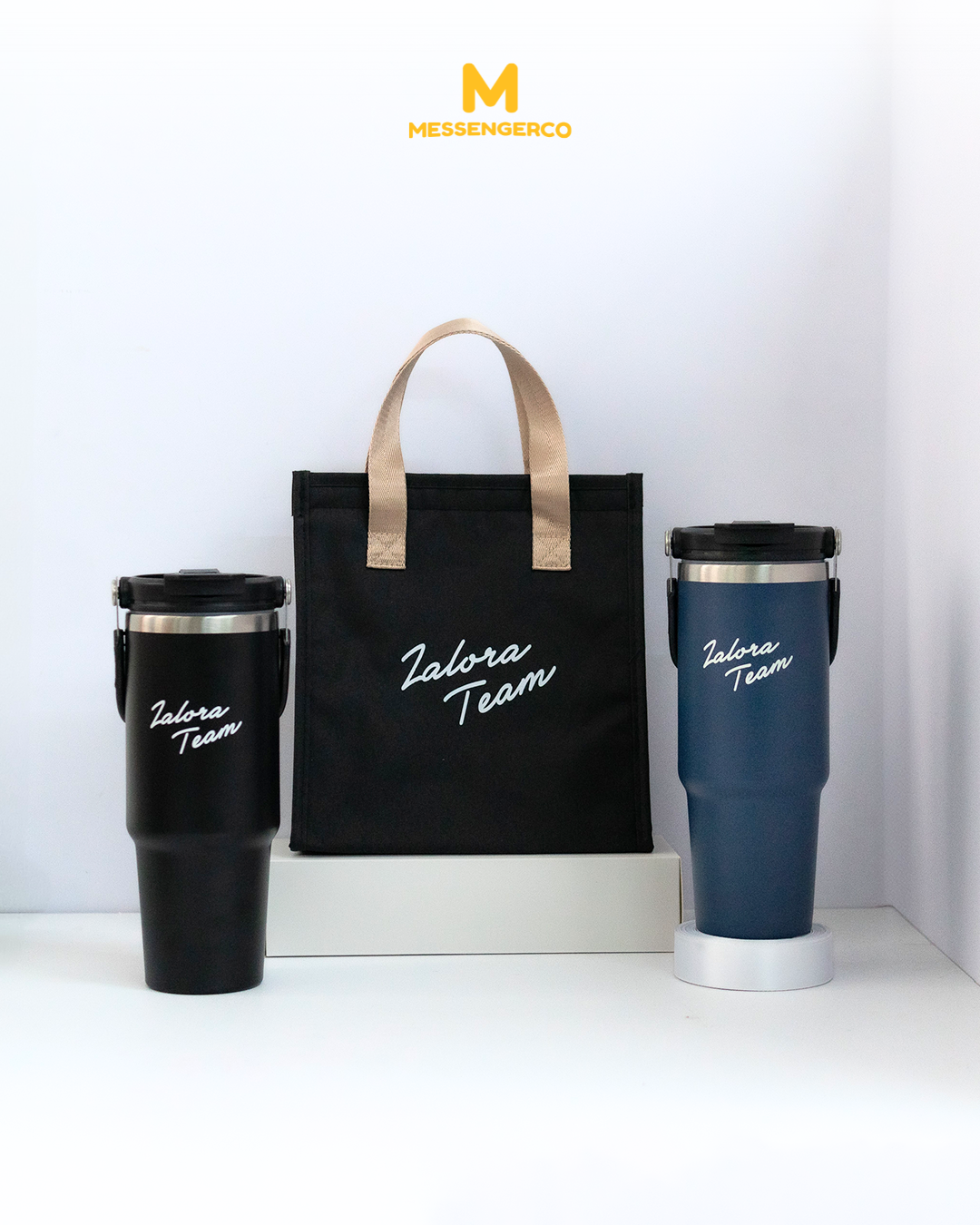 A lunch kit bag and stainless steel tumbler side by side, both featuring the ZALORA Team logo, ideal for corporate gifting or branded merchandise.
