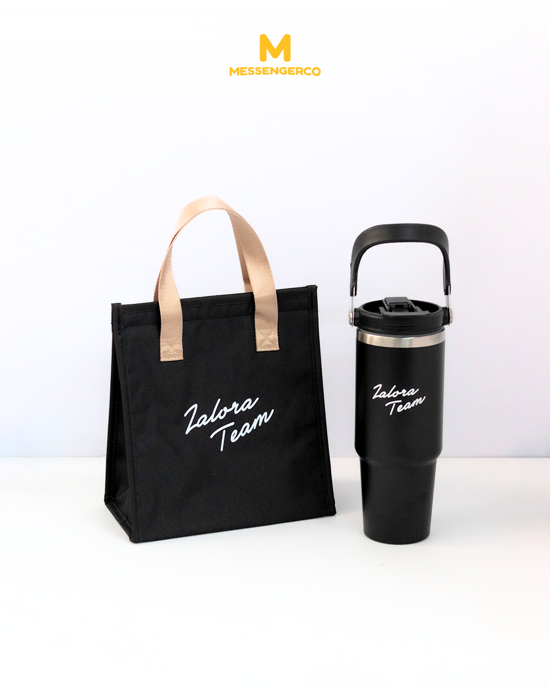 A black lunch kit bag paired with a matching tumbler, both featuring the Zalora Team logo; ideal for corporate branding and daily use.