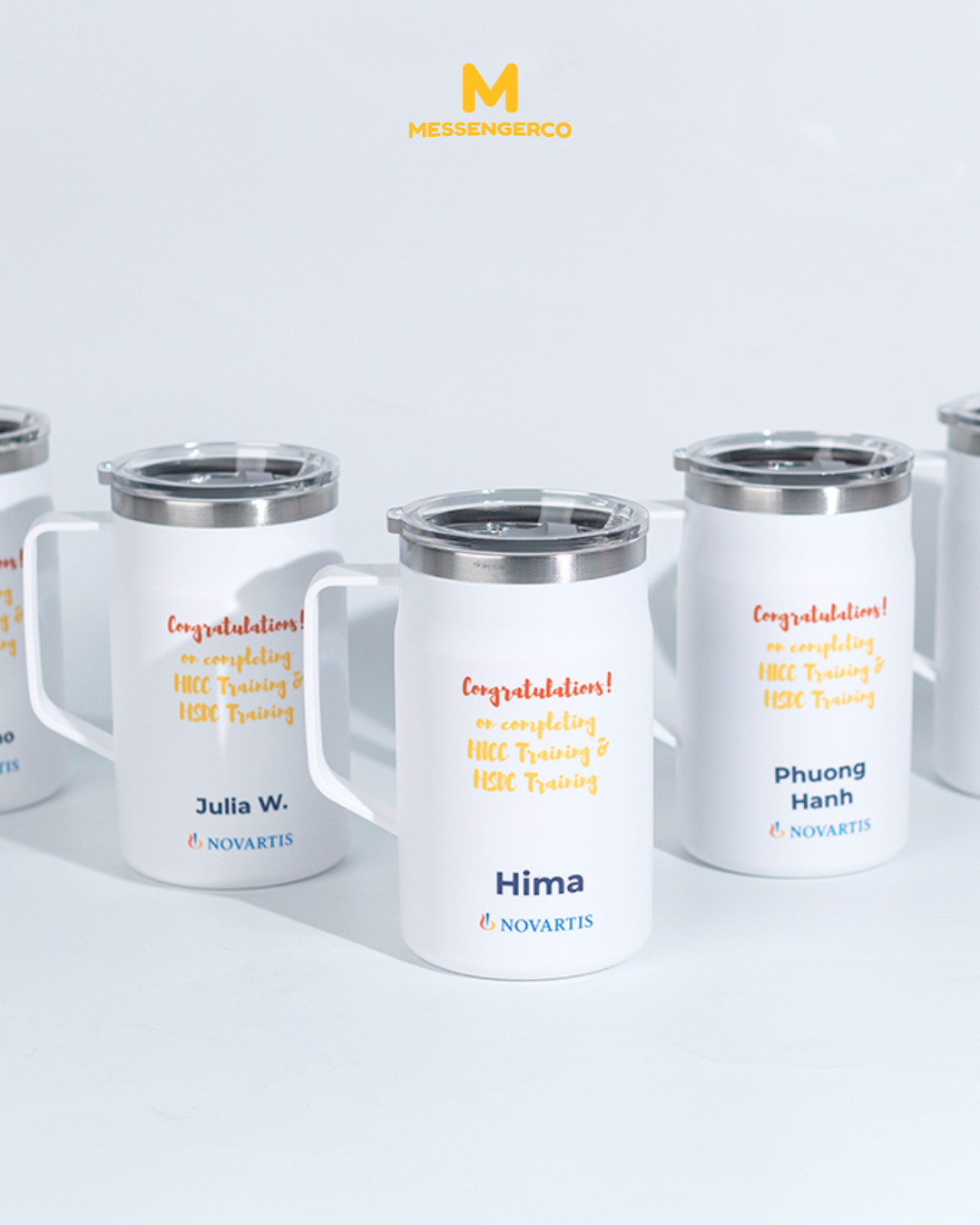A mug with a cover featuring the Novartis logo, ideal for corporate branding or promotional use.