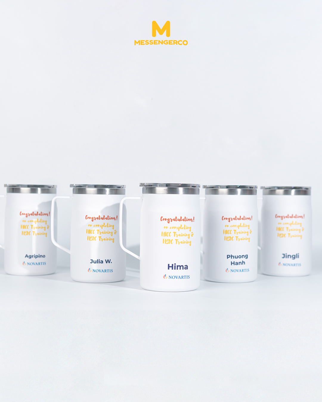 A ceramic mug with a lid, prominently printed with the Novartis logo, ideal for corporate branding or promotional use.