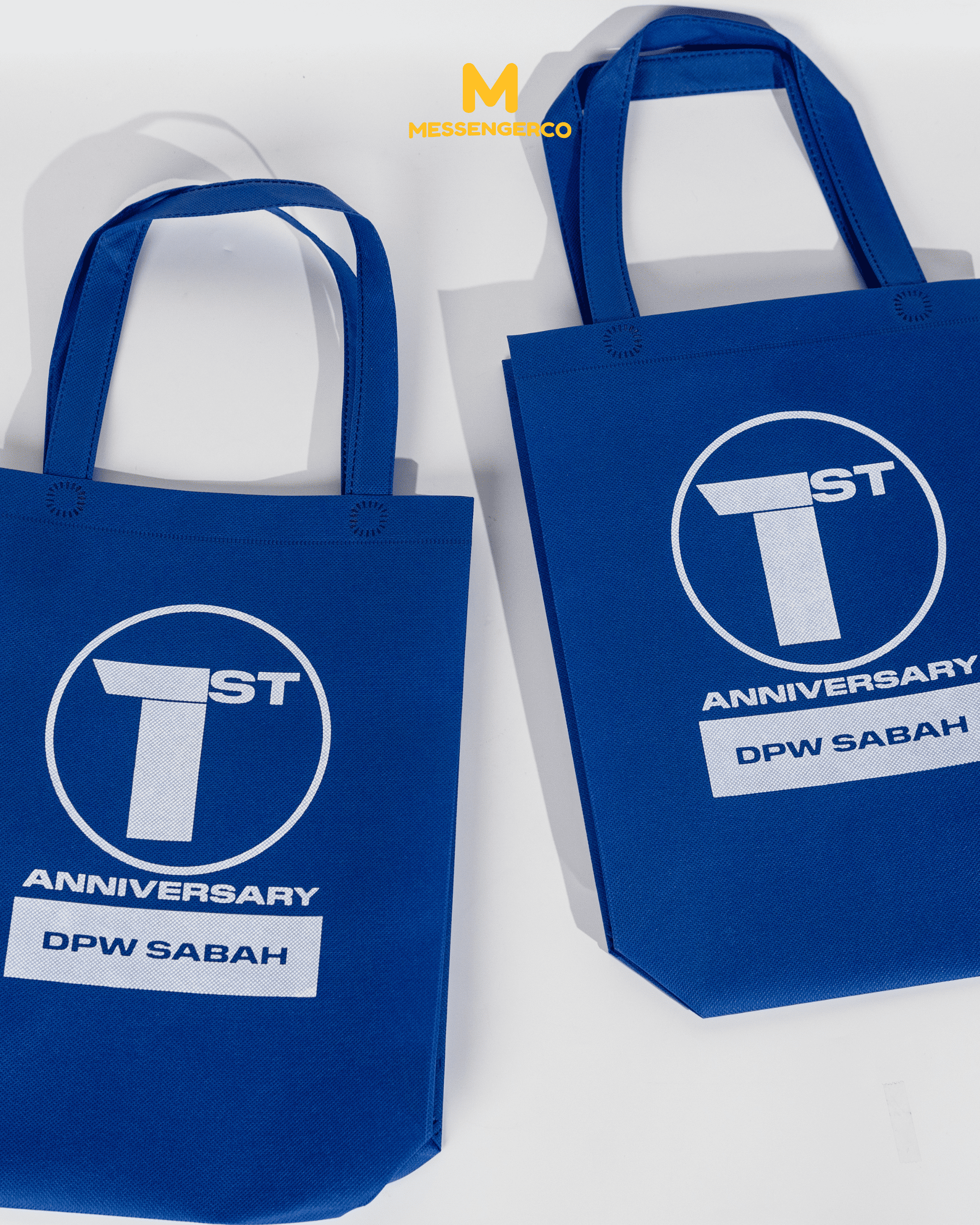 A custom designed non-woven bag for DPW Sabah, featuring a clean, simple pattern on a light background, ideal for eco-friendly marketing.