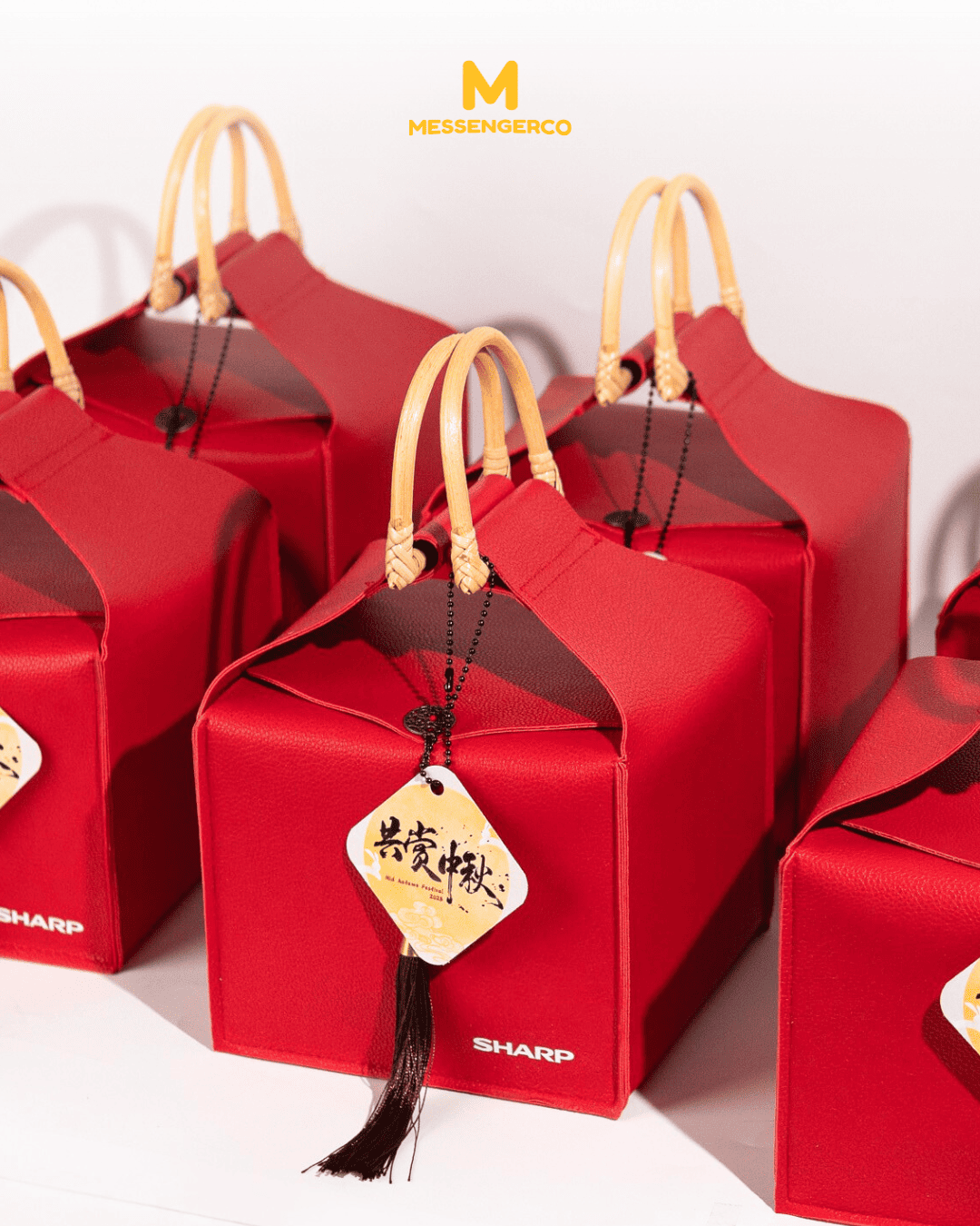 A red PU leather bag featuring a logo print and attached gift tag, ideal for gifting or personal use.