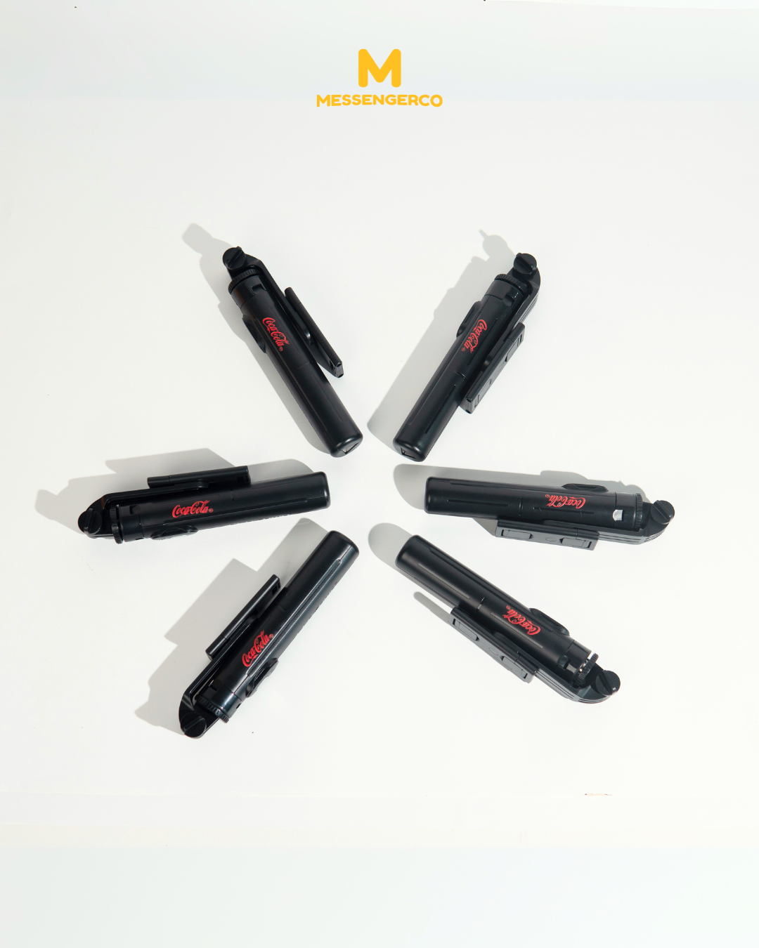 A tripod printed with the Coca-Cola logo, suitable for marketing or product showcases.