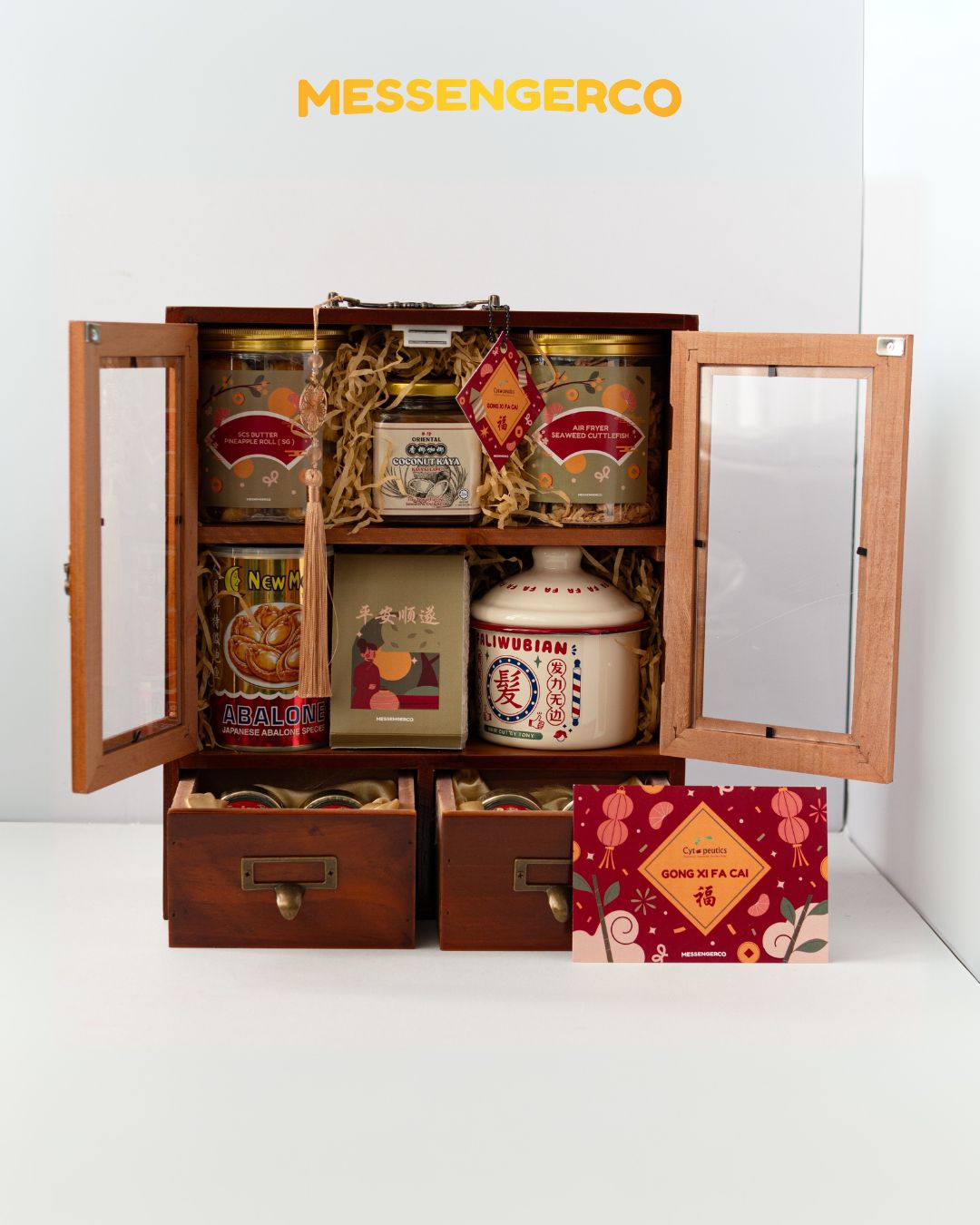 Open Rising Gold Chinese New Year hamper by MessengerCo with abalone, bird’s nest, snacks and vintage enamel mug in wooden case for festive corporate gifting.